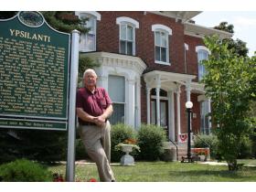 Al Rudisill, president of the Historical Society, stands in front of the Ypsilanti Historical Museum and Archives. The museum and archives, at 220 N. Huron St. will have special hours throughout the weekend.