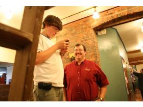 Forrest Karnopp (left) and his father Jim work late Tuesday night remodeling Cafe Luwak. 